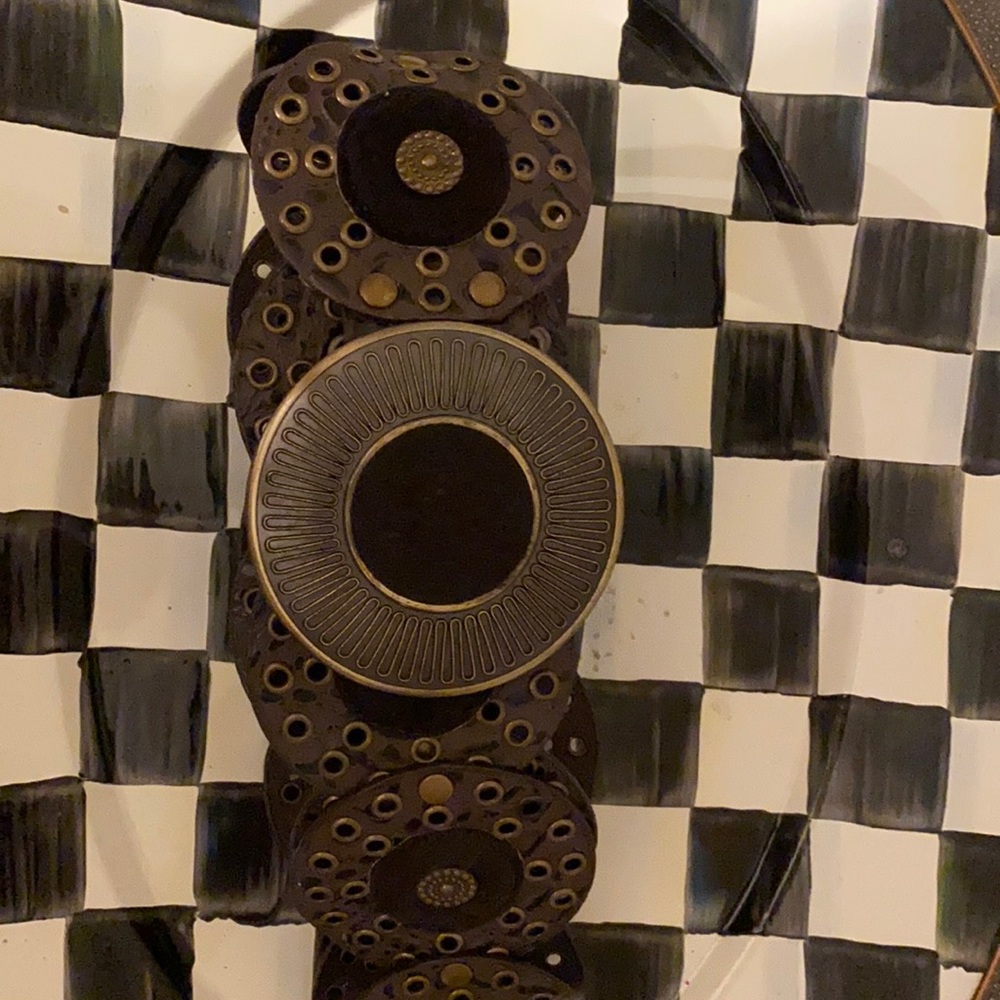 Leather belt with fur like detailing in circles.